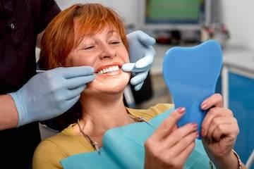 dentures west allis | woman at dentist